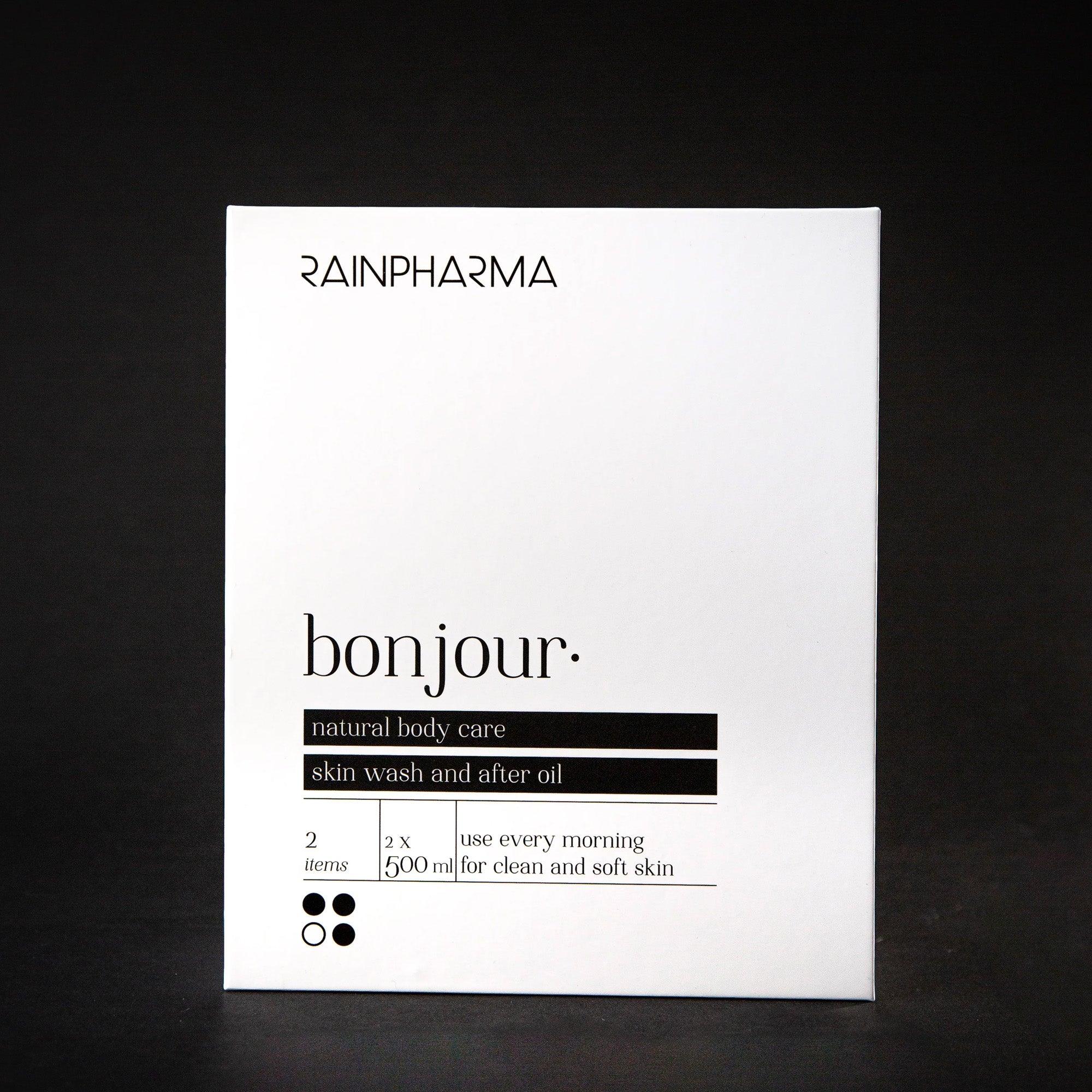 Een wit RainPharma doosje met de tekst "Bonjour Shower Duo - Skin Wash Bonjour + After Oil Bonjour 500ml," met gebruiksgegevens op een zwarte achtergrond, is perfect voor een energieke start met hoogwaardige producten.