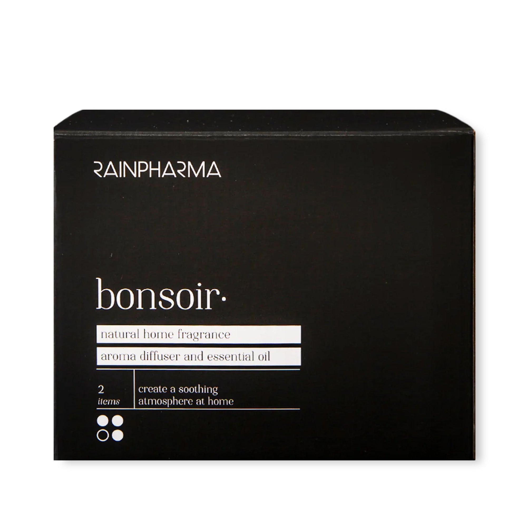 Een zwarte doos met het opschrift "RainPharma Aroma Diffuser Geschenkbox - Bonsoir" bevat een aroma diffuser en essentiële olie, met de tekst: "Creëer een rustgevende, ontspannende sfeer thuis." 2 items.