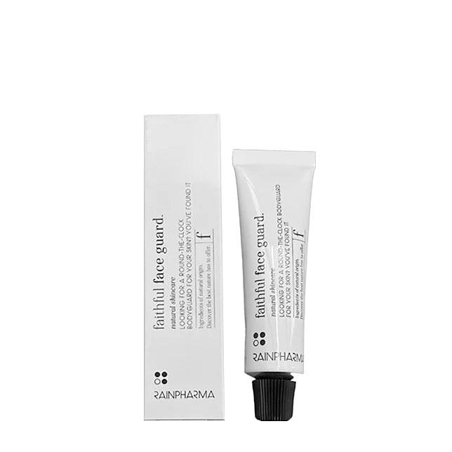 Het huidverzorgingsproduct Faithful Face Guard (dag- en nachtcrème) van RainPharma heeft zwarte tekst op een witte verpakking en is verrijkt met Tamanu-olie voor voeding.
