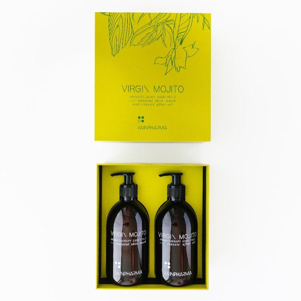 Twee pompflacons van "Douche Set - Virgin Mojito - Skin Wash + After Oil 500 ml" van RainPharma worden elegant gepresenteerd in een felgele Geschenkbox, met illustraties van groene bladeren en het kenmerkende RainPharma-merk.