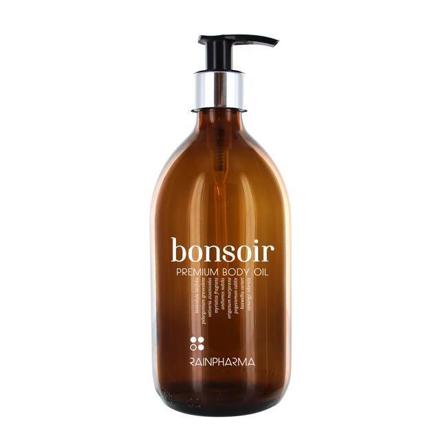 Een strakke bruine fles met een pompje, met het elegante label "Bonsoir Premium Body Oil" van RainPharma.