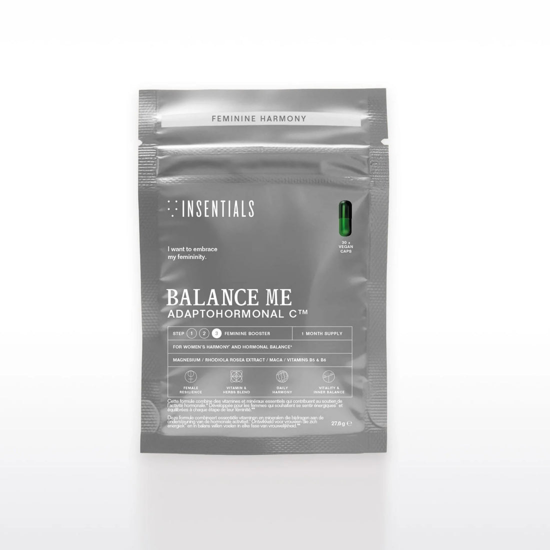 Een grijs pakje met het opschrift „Balance Me – Hormonale Balans &amp; Menopauze Support” van Insentials, met supplementen voor de vrouwelijke hormoonbalans met belangrijke ingrediënten zoals maca en een enkele groene capsule rechtsboven in beeld.