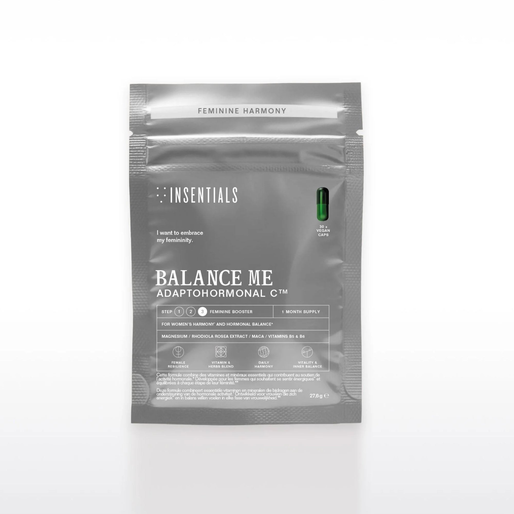Een grijs pakje met het opschrift „Balance Me – Hormonale Balans &amp; Menopauze Support” van Insentials, met supplementen voor de vrouwelijke hormoonbalans met belangrijke ingrediënten zoals maca en een enkele groene capsule rechtsboven in beeld.