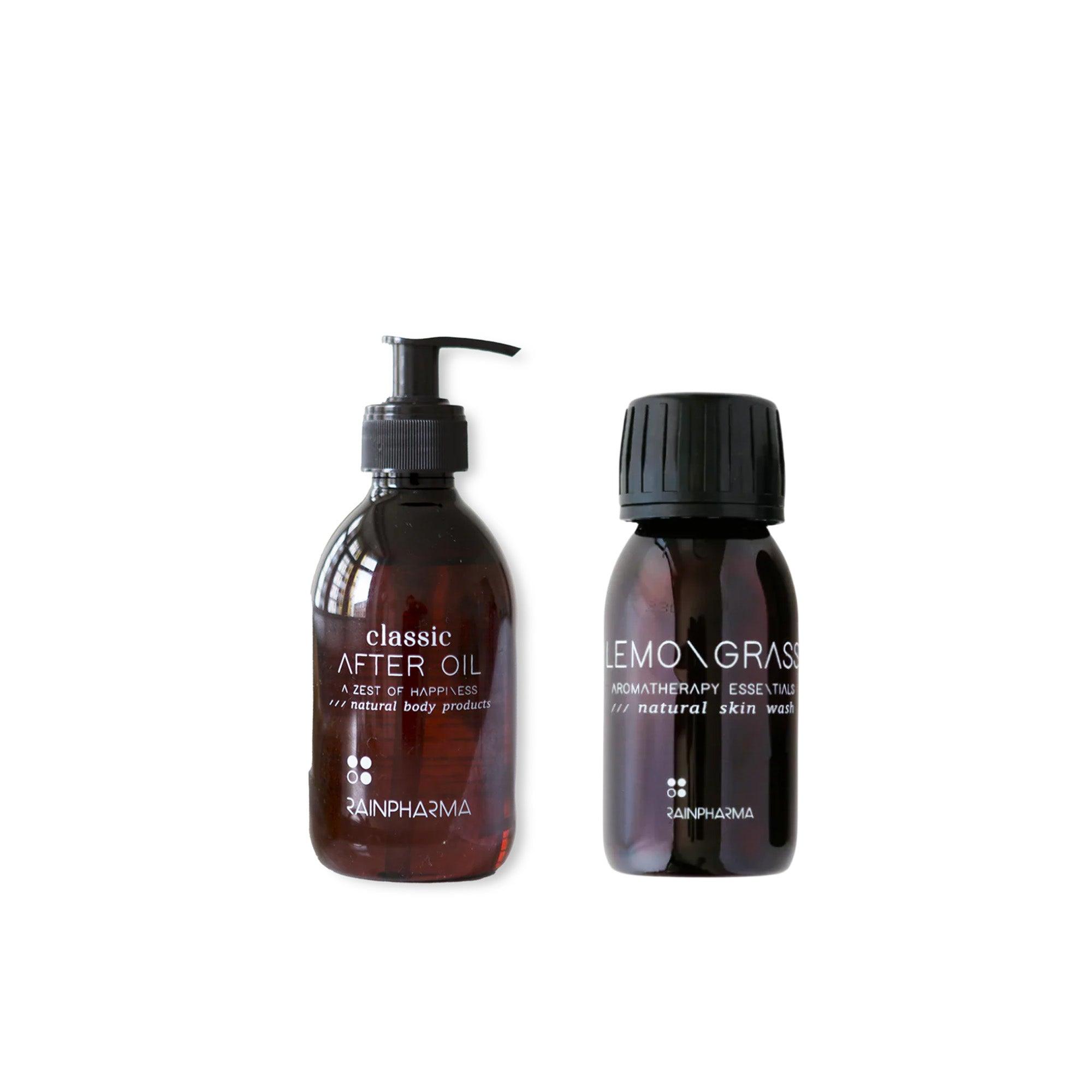 De RainPharma Bistro - Budget Gift Set, bestaande uit een donkerbruine &quot;Classic After Oil&quot; fles met een praktische pomp en een &quot;Lemongrass Aromatherapy Essential Natural Skin Wash&quot;, beide met zwarte doppen, geeft een spa-achtig gevoel. Deze set is een ideaal attent cadeau voor iedereen die op zoek is naar een verkwikkende reiniging en huidverzorging.