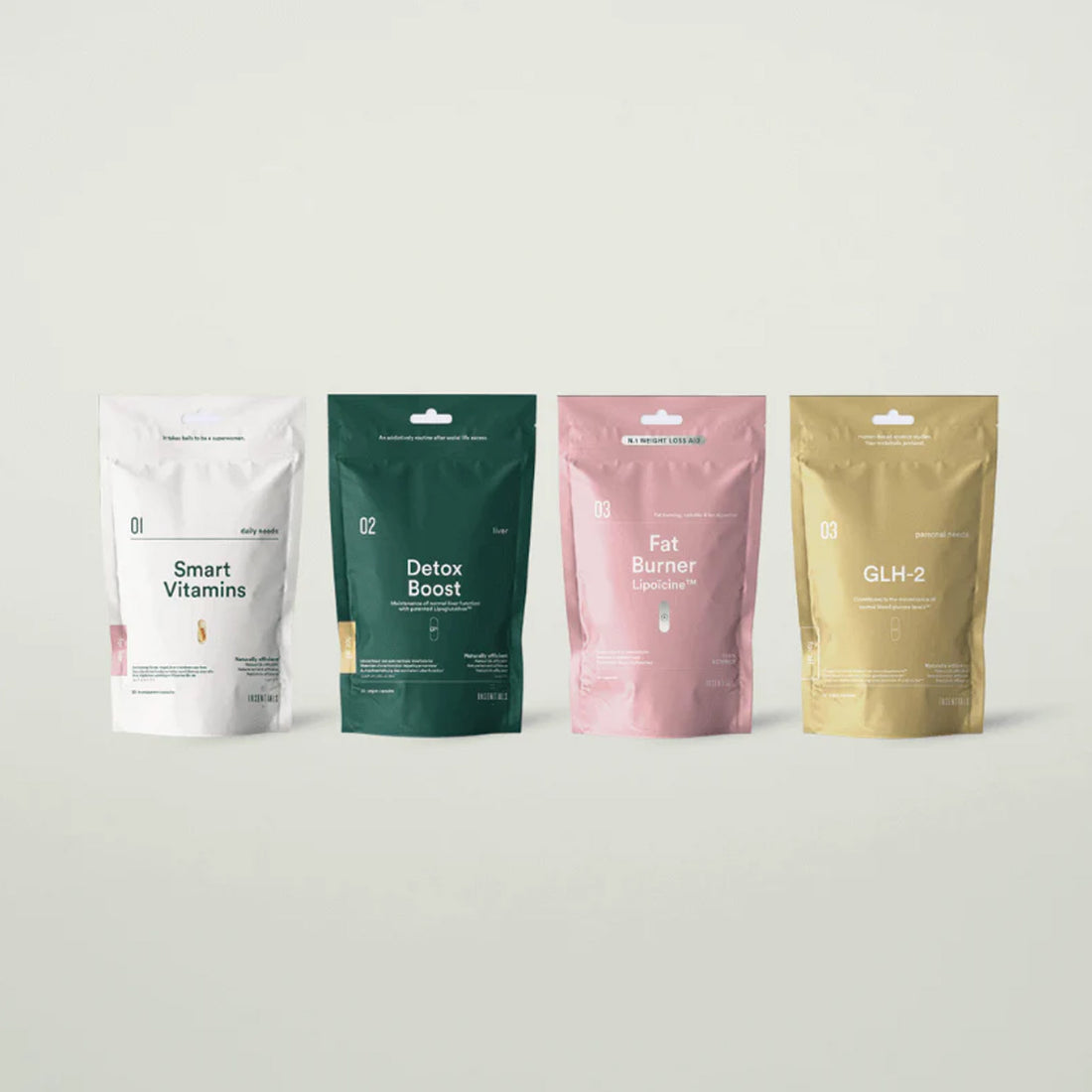 Vier kleurrijke hersluitbare Insentials-zakjes, waaronder de Smart Metabolic GLH-2 Pack, staan tegen een lichte achtergrond. Ideaal ter ondersteuning van detoxboost en natuurlijke vetverbranding.