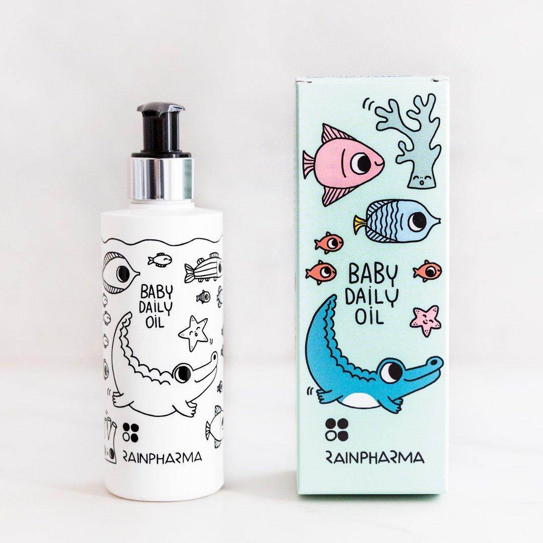 RainPharma Baby Daily Oil - 200 ml wordt geleverd in een fles en doos versierd met cartoon waterdieren op een witte achtergrond - perfect voor hypoallergene verzorging met natuurlijke babyolie.