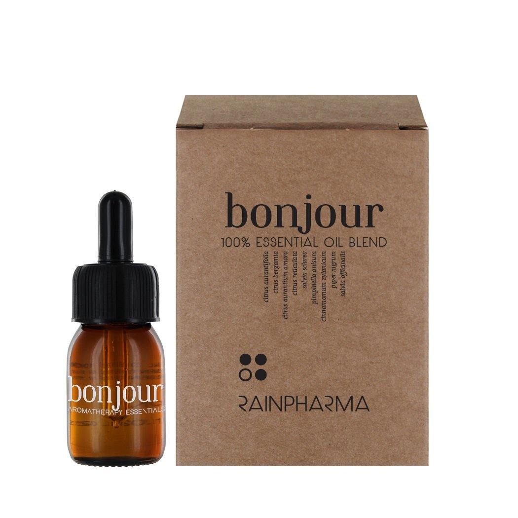 Een bruin glazen druppelflesje met het label &quot;RainPharma Essential Oil - Bonjour 30ml&quot; staat naast een bijpassend bruin kartonnen doosje, wat de hoogwaardige kwaliteit en therapeutische eigenschappen benadrukt.